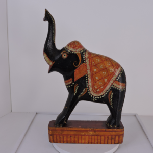 Hand-carved and hand-painted vintage Indian Kondapalli wooden elephant with ceremonial saddle and decorative floral patterns.