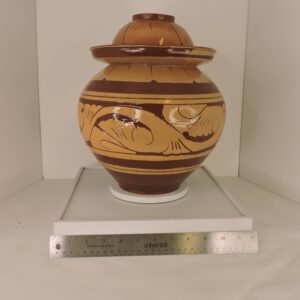 Large honey-glazed Chinese ginger jar from Gansu Province featuring raised traditional calligraphy on the lid and shoulder, viewed from multiple angles against a neutral background.