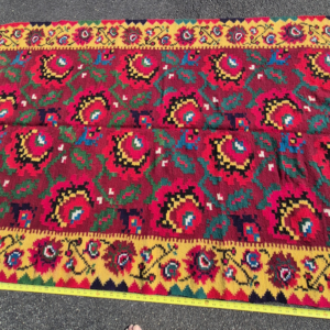 Full top view of a vintage 4'x7' Uzbek Suzani flatweave Kilim rug on asphalt, showcasing pixelated crimson floral medallions and thick yellow borders next to a yellow tape measure
