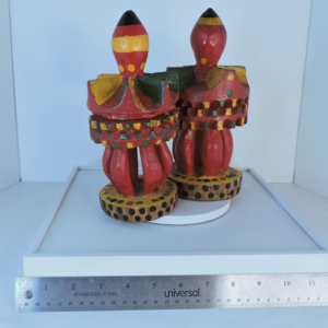 Pair of vintage hand-painted Mexican folk art wood totem figures with vibrant crown designs.